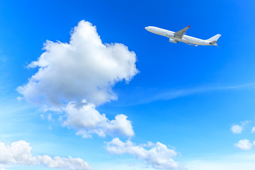 Naklejka na ściany i meble Airplane flying in the blue sky