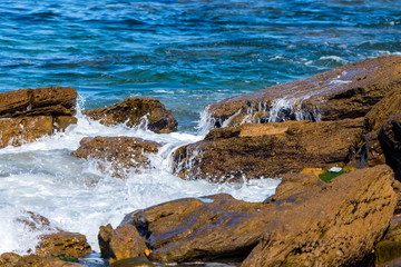 Aerial view of sea or ocean waves and some of rocks