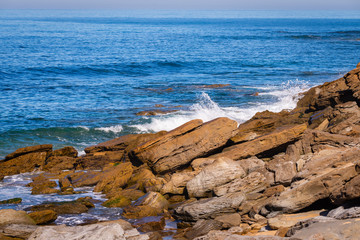 Aerial view of sea or ocean waves and some of rocks