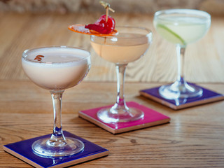 different colorful alcohol and non-alcohol cocktails in the glasses on the table