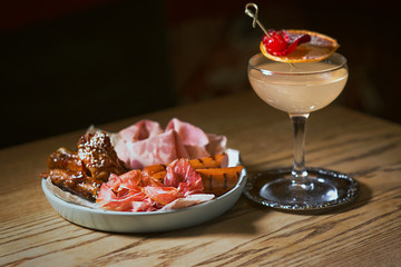 antipasto, antipasti - plate with pate, prosciutto, bread, cheese, salami, ham, sausage, pork, hummus, mustard, tomato and cocktail