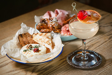 antipasto, antipasti - plate with pate, prosciutto, bread, cheese, salami, ham, sausage, pork, hummus, mustard, tomato and cocktail