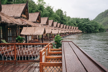 Old vintage planked wood table in Resort home raft floating, river kwai at sai...