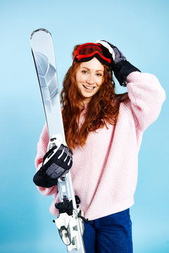 Portrait of smiling girl holding her skis