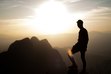 Fototapeta premium silhouette of man on top of mountain