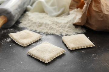 Tasty ravioli on table