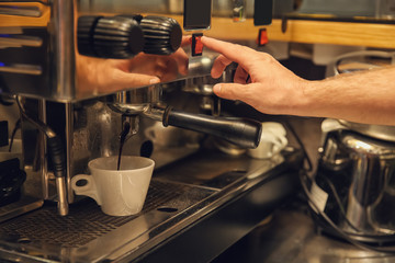 Barista preparing fresh aromatic coffee in cafe