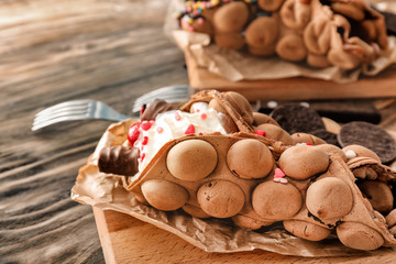 Delicious sweet bubble waffle on wooden table