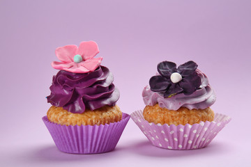 Tasty cupcakes on color background