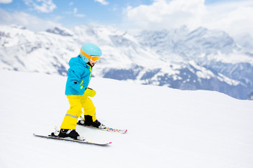 Fototapeta na wymiar Ski and snow winter fun for kids. Children skiing.