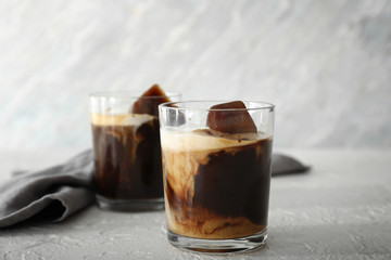Glass of cold coffee on light table