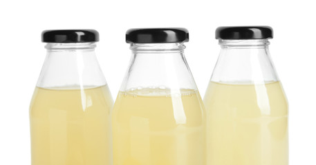 Bottles of fresh lemonade on white background