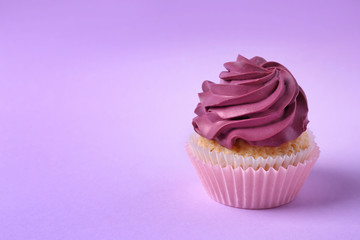 Tasty cupcake on color background