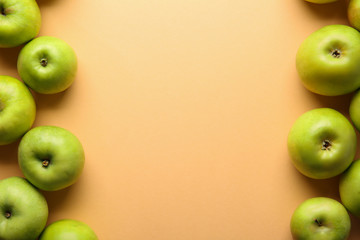 Ripe tasty apples on color background, top view