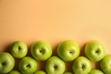 Ripe tasty apples on color background, top view