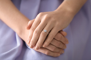 Young woman with engagement ring on her finger, closeup