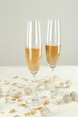 Glasses of champagne with decor on white table