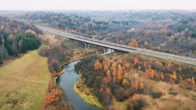 Highway Bridge through Autumn River Valley, Aerial Hyperlapse