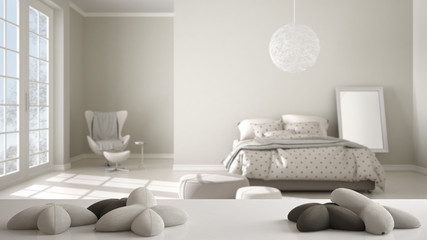 White table, desk or shelf with five soft white pillows in the shape of stars or flowers, over blurred modern bedroom, white architecture interior design concept
