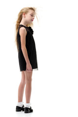 Fototapeta premium Little girl in a dress developing in the wind.