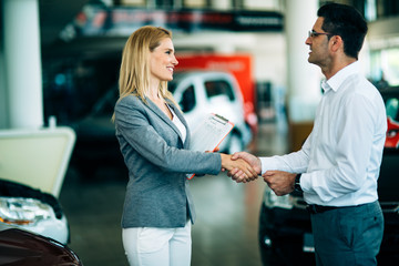 Portrait of happy customer buying new car