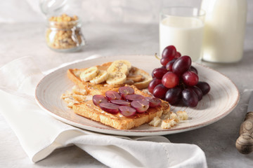 Plate with different delicious toasts on table