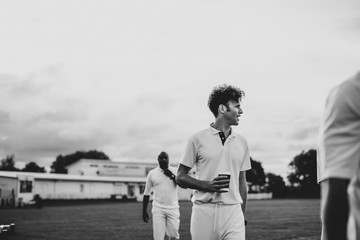 Cricket player holding a coffee paper cup