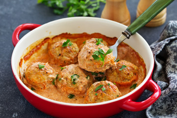 Meatballs in a creamy tomato sauce.
