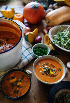 Bowls of pumpkin soup on a table