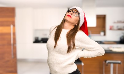 Girl with celebrating the christmas holidays suffering from backache for having made an effort at home