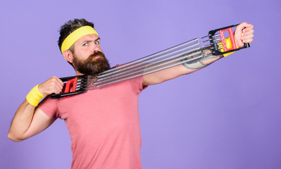 Sportsman wear retro outfit training violet background. Athlete sport instructor. Athlete training with chest expander. Man bearded athlete exercising with expander equipment. Join my sport class