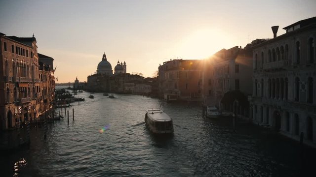 Italian port. Sunset. Boats sailing on the river.