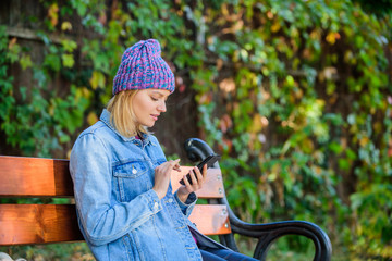 I am waiting for you in park. Girl busy with phone nature background. Woman messaging mobile phone....