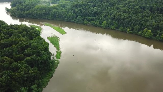 Forward shot over the water and the trees in the mountains