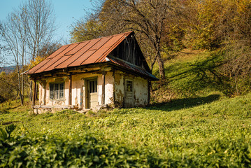 Old abandoned house in the countryside with broken roof and windows