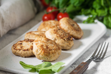 Chicken cutlets on white Board on white background