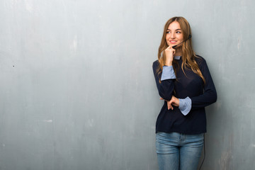 Telemarketer woman looking to the side with the hand on the chin