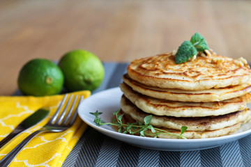 Fresh, delicious pancakes with walnuts on wooden table
