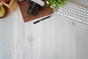 Top view shot of wooden office desktop with office supplies and copy space