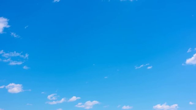 Beautiful almost clear blue sky with light white clouds - timelapse 4K