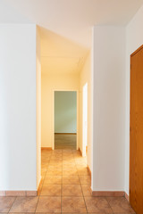 Corridor with vintage tiles, open doors
