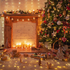 Christmas composition, decorated fireplace with wood mantelpiece, lit up Christmas tree with baubles, stars, Christmas lights on the floor, wooden ornaments and lit up candles, selective focus