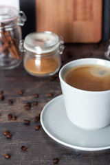 black coffee on wooden kitchen table close-up.