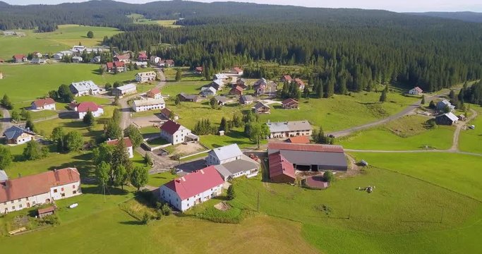 Aerial, drone shot, of a small town, in the french countryside, on a sunny day, in Chapelle des bois, Doubs and Jura regional park, Franche comt&radic;&copy;, in France