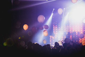 Balloons flying over the crowd during the concert. Live show