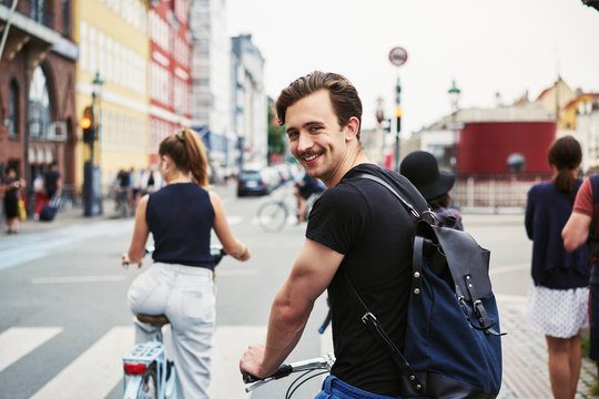 Young man riding a bicycle in Copenhagen, Denmark