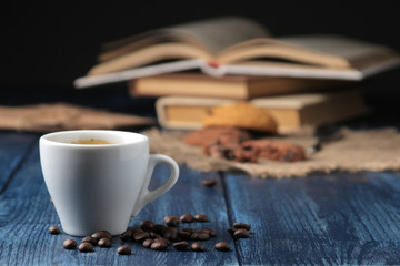 Natural espresso coffee in a ceramic coffee cup in the foreground on a blue wooden table. with space for text
