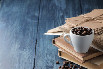 coffee cup for espresso and coffee beans on a blue wooden table with space for inscription