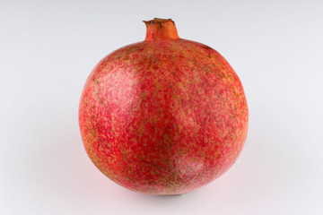 A whole pomegranate on a white background