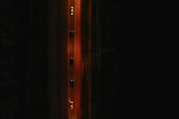 View over the roadway with cars at night. Beautiful aerial view on the night road.